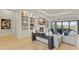 Bright living room features custom built-ins, a fireplace and large windows with views of the outdoors at 14803 Derna Ter, Bradenton, FL 34211