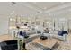 Bright, open-concept living room and kitchen area with modern decor and hardwood flooring at 14803 Derna Ter, Bradenton, FL 34211