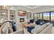Cozy living room features a fireplace, built-in shelves, and a view of the outdoor living space at 14803 Derna Ter, Bradenton, FL 34211
