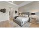 Spacious main bedroom with a tufted headboard, decorative wall art, and warm, inviting decor at 14803 Derna Ter, Bradenton, FL 34211