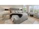 Elegantly designed main bedroom with tufted headboard and bay window seating area with a view at 14803 Derna Ter, Bradenton, FL 34211