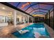 Gorgeous outdoor living space features a screened pool, lounge chairs, and a covered patio at 14803 Derna Ter, Bradenton, FL 34211