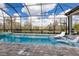 Inviting screened-in pool with lounge chairs and scenic views of the lush landscaping at 14803 Derna Ter, Bradenton, FL 34211