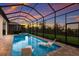 Screened pool with brick trim, sunset views, and lounge chairs for relaxing poolside at 14803 Derna Ter, Bradenton, FL 34211