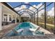 Beautiful screened pool features stylish loungers, lush landscaping and outdoor living spaces at 14803 Derna Ter, Bradenton, FL 34211