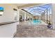 Inviting, screened-in pool featuring comfortable lounge chairs and views of the home's interior at 14803 Derna Ter, Bradenton, FL 34211