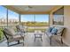 Relaxing screened balcony with comfortable seating and views of the golf course and water at 1620 Fairway Trce # B, Palmetto, FL 34221