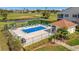 Relaxing community pool and lounging area with a covered pergola at 1620 Fairway Trce # B, Palmetto, FL 34221