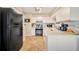 Bright kitchen features white cabinetry, tile floors, and modern appliances at 1620 Fairway Trce # B, Palmetto, FL 34221
