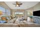 Inviting living room featuring tile flooring, ceiling fan, and access to the balcony and other rooms at 1620 Fairway Trce # B, Palmetto, FL 34221