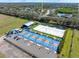 Aerial view shows community amenities that includes pickle ball courts, beach volleyball and recreation areas at 209 111Th E St, Bradenton, FL 34212