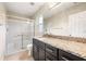 Modern bathroom featuring granite counters, shower with sliding glass doors, and updated fixtures at 209 111Th E St, Bradenton, FL 34212