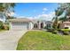 Charming single-story home featuring a well-maintained lawn and two-car garage at 209 111Th E St, Bradenton, FL 34212