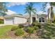 Home exterior showing the manicured lawn and freshly mulched shrubbery beds at 209 111Th E St, Bradenton, FL 34212