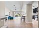 Open-concept living room with tile floors flowing into the kitchen and access to the lanai at 209 111Th E St, Bradenton, FL 34212