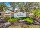 Entrance sign for gated community 'Gates Creek', complemented by lush landscaping and stone accents at 209 111Th E St, Bradenton, FL 34212