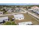 Overhead view of a charming single-Gathering home situated in a tranquil residential area with verdant surroundings at 211 Dalton Blvd, Port Charlotte, FL 33952