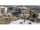 Stunning aerial view of beachfront condos with pools, lush landscaping, and private beach access at 2141 Gulf Of Mexico Dr Unit # 4, Longboat Key, FL 34228