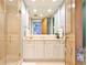 Bathroom showcasing a marble vanity with gold fixtures, a large mirror, and a glass-enclosed shower at 2141 Gulf Of Mexico Dr Unit # 4, Longboat Key, FL 34228