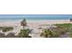 Stunning beach view with palm trees along the sandy beach and clear ocean at 2141 Gulf Of Mexico Dr Unit # 4, Longboat Key, FL 34228