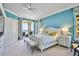 Cozy bedroom showcasing a queen-sized bed, balcony access with ocean view, and stylish coastal decor at 2141 Gulf Of Mexico Dr Unit # 4, Longboat Key, FL 34228