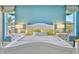 Tranquil bedroom featuring a queen-sized bed, decorative lamps, and windows offering ample natural light at 2141 Gulf Of Mexico Dr Unit # 4, Longboat Key, FL 34228