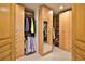 Walk-in closet with custom wood cabinets and shelving, providing ample storage space at 2141 Gulf Of Mexico Dr Unit # 4, Longboat Key, FL 34228