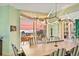 Elegant dining room with ocean view and modern lighting fixture at 2141 Gulf Of Mexico Dr Unit # 4, Longboat Key, FL 34228