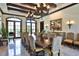 Elegant dining room with large table, chandelier, and natural lighting at 2141 Gulf Of Mexico Dr Unit # 4, Longboat Key, FL 34228