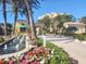 Beautiful condo entrance with fountain, colorful flowers, and manicured landscaping at 2141 Gulf Of Mexico Dr Unit # 4, Longboat Key, FL 34228