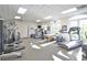 Well-equipped gym featuring modern equipment and natural light from large arched windows at 2141 Gulf Of Mexico Dr Unit # 4, Longboat Key, FL 34228