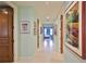 Hallway featuring marble floors, neutral walls, and artistic decor, leading to various rooms in the house at 2141 Gulf Of Mexico Dr Unit # 4, Longboat Key, FL 34228