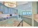 Charming kitchen with modern appliances, breakfast bar, and views of the oceanfront living space at 2141 Gulf Of Mexico Dr Unit # 4, Longboat Key, FL 34228