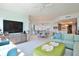 Open-concept living room with large TV, comfortable seating, and seamless access to the dining area and kitchen at 2141 Gulf Of Mexico Dr Unit # 4, Longboat Key, FL 34228