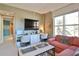 Comfortable living room with dual workstations, large windows, and stylish decor with seating and natural light at 2141 Gulf Of Mexico Dr Unit # 4, Longboat Key, FL 34228