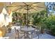 Charming outdoor patio with dining furniture, lush greenery, and serene fountain at 2141 Gulf Of Mexico Dr Unit # 4, Longboat Key, FL 34228