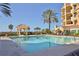 The pool is surrounded by palm trees and offers views of the beach and ocean at 2141 Gulf Of Mexico Dr Unit # 4, Longboat Key, FL 34228