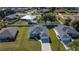 Aerial view of a home with a well-kept lawn, mature trees, and surrounding residences at 2186 Yalta Ter, North Port, FL 34286
