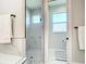Modern bathroom features dual sinks, a glass-enclosed shower, and a toilet room at 2186 Yalta Ter, North Port, FL 34286