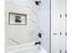 Chic bathroom featuring marble tiling, sleek fixtures, and recessed shelving in the shower for storage at 2186 Yalta Ter, North Port, FL 34286