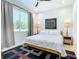 Charming bedroom with a large window, decorative art, ambient lighting, and a stylish patterned rug at 2186 Yalta Ter, North Port, FL 34286
