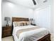 Cozy bedroom with a ceiling fan, a wooden headboard, side tables, and a closet for ample storage space at 2186 Yalta Ter, North Port, FL 34286