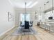 Bright dining room with modern light fixture and a view of the kitchen; open and airy space at 2186 Yalta Ter, North Port, FL 34286