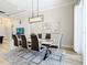 Bright, open dining room features modern furnishings, art, and views to the living room and kitchen at 2186 Yalta Ter, North Port, FL 34286