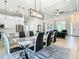 Open concept living space features kitchen, dining area with modern furniture, and view to living room at 2186 Yalta Ter, North Port, FL 34286