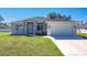 Well-manicured lawn and tidy landscaping complement this single Gathering home's neutral exterior at 2186 Yalta Ter, North Port, FL 34286