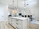 Open floor plan shows the kitchen island, dining room, and living room with modern furnishings and light-toned walls at 2186 Yalta Ter, North Port, FL 34286