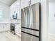 Modern kitchen with stainless steel appliances, white cabinets, and stylish backsplash at 2186 Yalta Ter, North Port, FL 34286