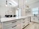 Bright kitchen showcases a large island, white cabinetry with dark hardware, and modern pendant lighting at 2186 Yalta Ter, North Port, FL 34286