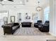 Spacious living room featuring leather furniture, modern lighting, and hardwood floors at 2186 Yalta Ter, North Port, FL 34286